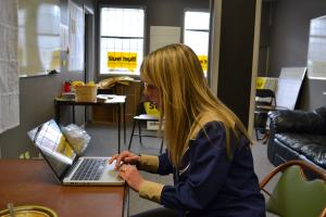 Sue Huff tweets from a laptop in her campaign office