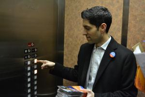 Akash Khokhar presses the elevator buttons in a downtown apartment building