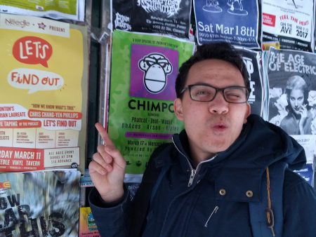 Me pointing at one of the posters for the Let's Find Out live show on a billboard on Jasper Ave.