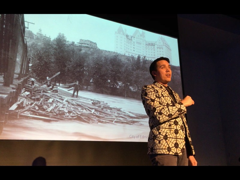 Chris speaking in front of a slide of the 1915 flood